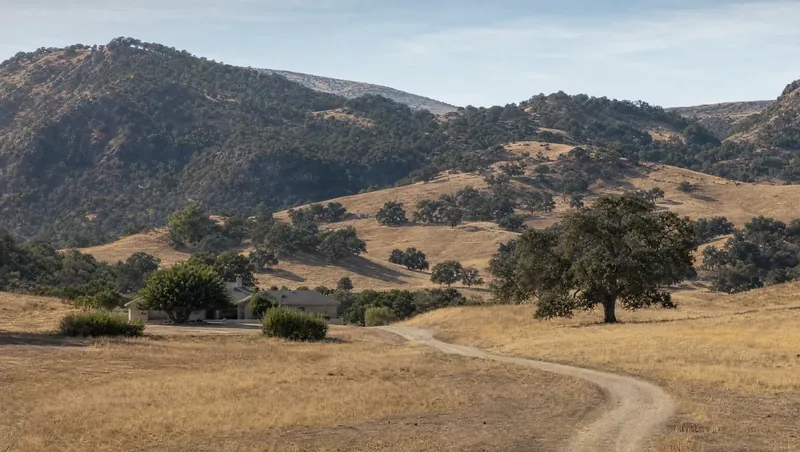 Kern County, California: Dry golden hills with scattered oaks, chaparral higher up; ranch home on a dirt road