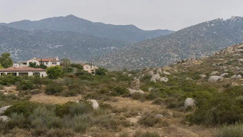 Riverside County, California: Boulder-strewn chaparral hills; stucco homes with red tile roofs right at the wildland edge